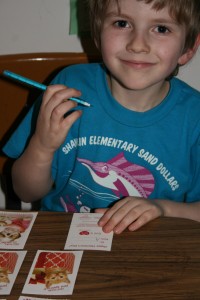 Alexander filling out his first Valentine cards